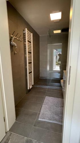 a bathroom with a shower with a toilet and a rug at OASE im grünen Hinterhof, EG, Ruhe, Terrasse, Carport, free PayTV, Kaffee&Tee, Fahrräder in Duisburg