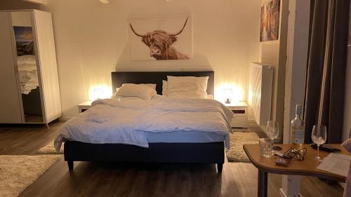 a bedroom with a bed with a bull head on the wall at OASE im grünen Hinterhof, EG, Ruhe, Terrasse, Carport, free PayTV, Kaffee&Tee, Fahrräder in Duisburg