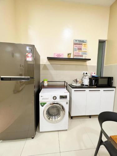 a kitchen with a washing machine and a refrigerator at Maison life 小居屋 The Loft Imago in Kota Kinabalu