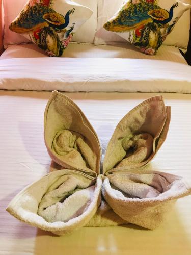 a hotel room with a towel on a bed at Shristi Hotel & Lodge in Bandīpur