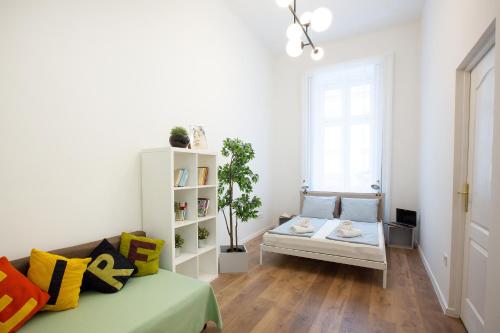 a living room with a couch and a window at Friends Hostel & Apartments in Budapest