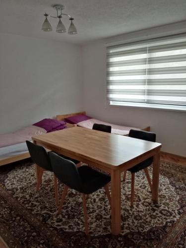 a dining room with a wooden table and chairs at Azra in Visoko