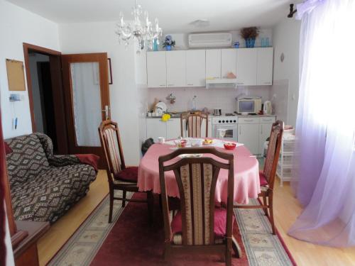 a kitchen with a table with a pink table cloth at Wisteria in Tivat