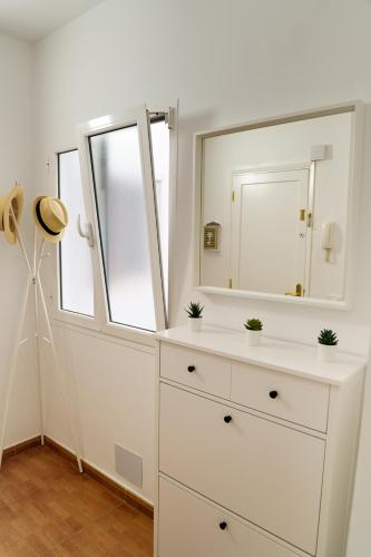 a bathroom with a white dresser with a mirror at Risco Verde Paradise in Arinaga