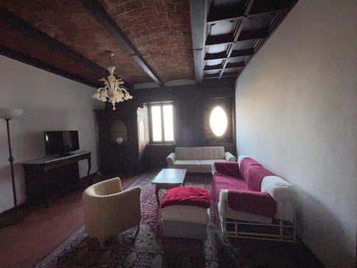 a living room with a couch and chairs and a table at Agriturismo Poderi Zunino in Ponti