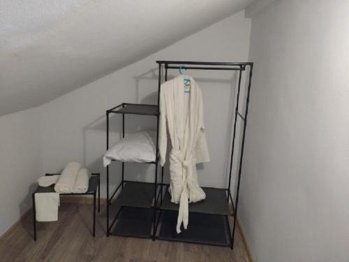 a white robe on a rack in a room at Lake House Gyumri in Noraber