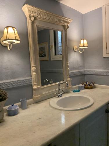 a bathroom with a sink and a mirror at Villa Irene Blue in Krotiri