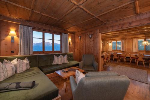a living room with a couch and chairs and a table at Golmerhaus in Schruns