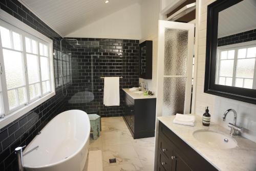 a large bathroom with a tub and a sink at Heal House in Brisbane