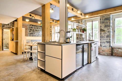 a kitchen with a sink and a counter top at Hotel AtypiQ in Quebec City