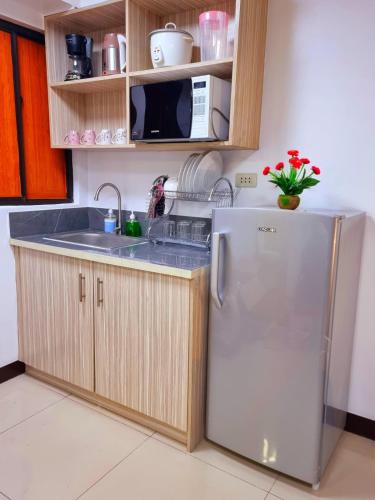 a kitchen with a refrigerator and a sink at Fetalino's Place Imus in Imus