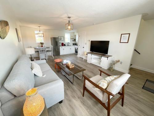 a living room with a couch and a table at Gateway to Greenwich Suites in Saint Peters