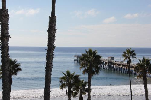 a view of the ocean from a beach with palm trees at Sea Horse Resort in San Clemente