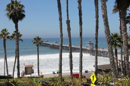 a view of the beach from a resort with palm trees at Sea Horse Resort in San Clemente