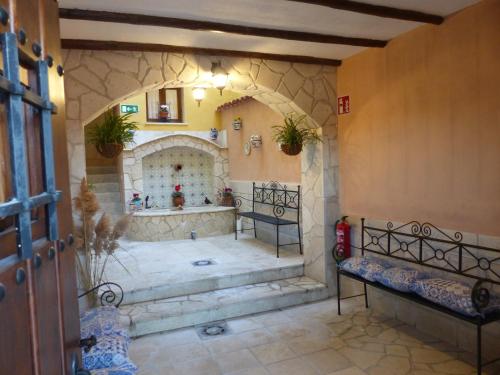 a room with two benches and a fireplace at Casa de la Abuela Pili in Colmenar de Oreja