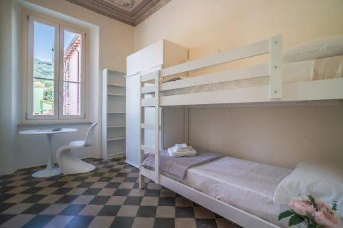 a bedroom with a bunk bed and a desk at Casa Mati in Deiva Marina