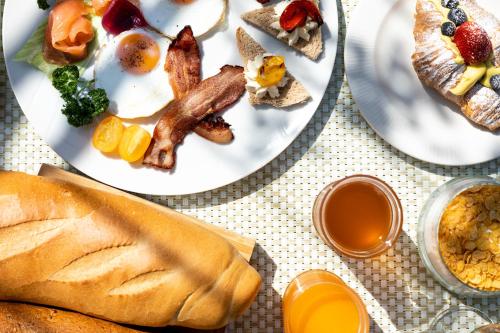 a plate of breakfast foods on a table at Hotel Aquila D'Oro Desenzano in Desenzano del Garda