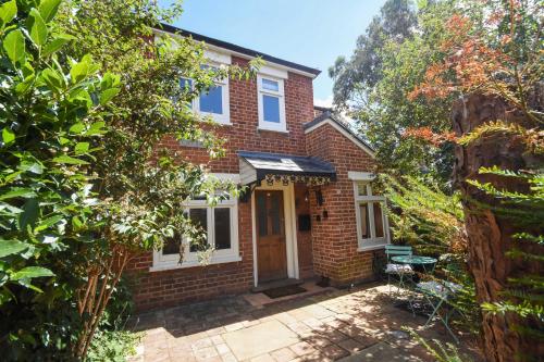 a brick house with a front door and trees at Unique period one bedroom house in Colchester in Colchester