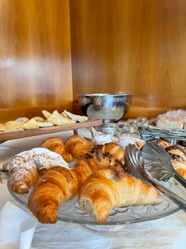 a tray of croissants and other pastries on a table at Hotel Gattapone in Spoleto