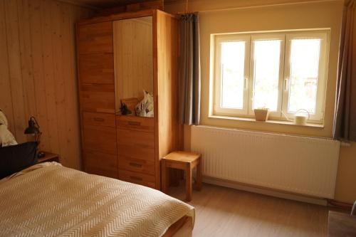 a bedroom with a bed and a window and a dresser at Apartment Sonnenschein in Weimar