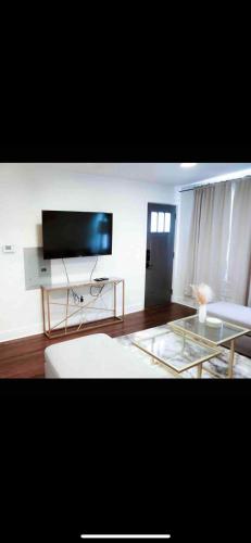 a living room with a couch and a flat screen tv at Lovely 1-bedroom rental unit with free parking in Washington, D.C.