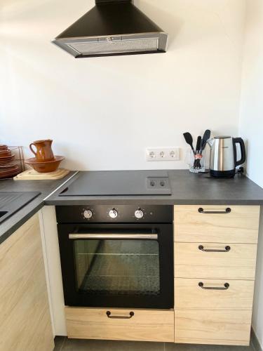 a kitchen with a black stove top oven at Finca Sa Canova Agroturismo in Campos