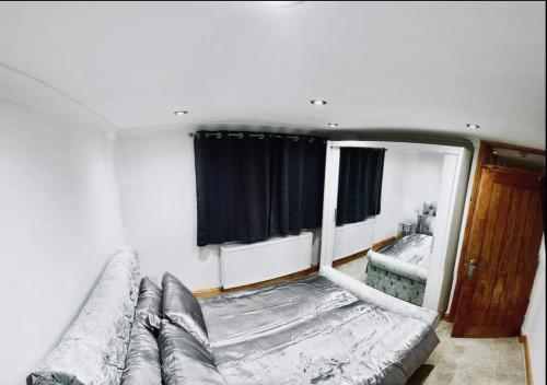 a living room with a couch and a window at Stratford city apartments in London