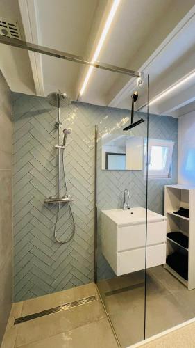 a bathroom with a sink and a glass shower at Kustverhuur, Park Schoneveld, Zeester 63 in Breskens