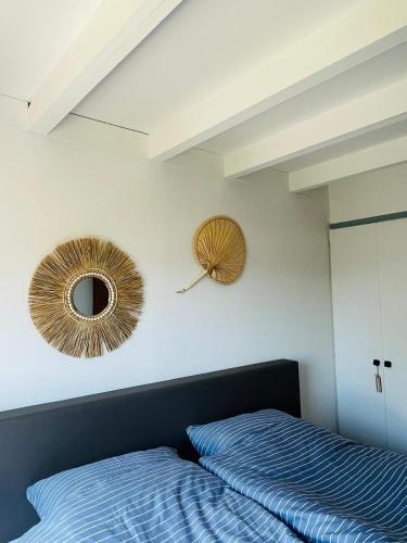 a bedroom with two beds and a mirror on the wall at Kustverhuur, Park Schoneveld, Zeester 63 in Breskens