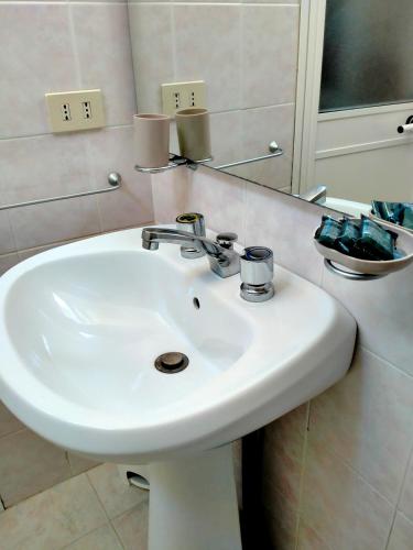 a white sink in a bathroom with a mirror at B&blavenza in Carrara