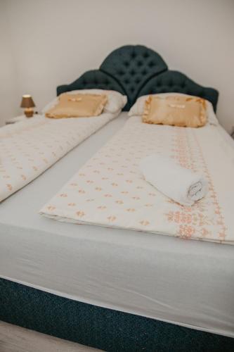 two beds sitting next to each other in a room at Guest House Ahmo Halilcevic in Dubrave Gornje