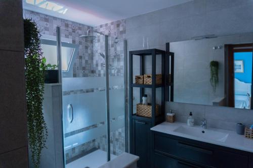bagno con doccia, lavandino e specchio di Beautiful Málaga House - Holidays a Málaga