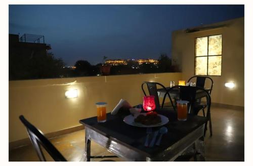 a table with a plate of food and a candle on it at Hotel haritage desert safari in Jaisalmer