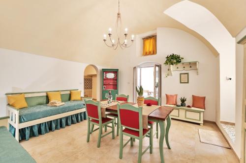 a living room with a table and a couch at SIGNURIA APARTMENT in Gallipoli