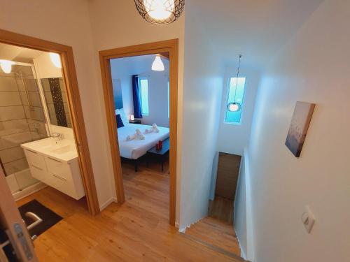 a bathroom with a sink and a mirror at La Volcane - Maison au calme des Bois Royaux in Le Chesnay