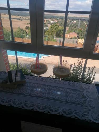 a window with a view of a beach and a pool at LOS PRUNOS in Maello
