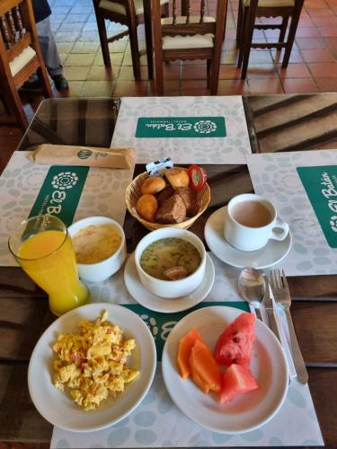 a table topped with plates of food at Hotel Termales El Batan in Cuítiva