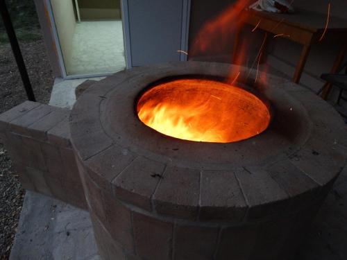 a fire pit with a fire burning in it at Village Jazz in Chimankend