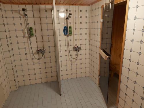 a bathroom with a shower and a stall with a shower at Apartment Junki in Alavieska