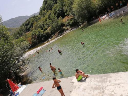 a group of people in the water at a beach at Motel and Restaurant Odušak in Drežnjak