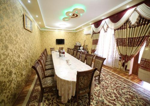 a dining room with a long table and chairs at Murod Yusufiy Boutique Hotel in Bukhara