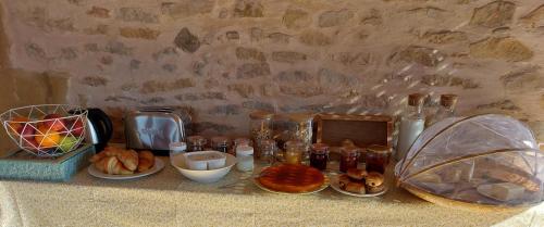 バニョルにあるSonges de vigneの壁の横に食べ物の皿が置かれたテーブル