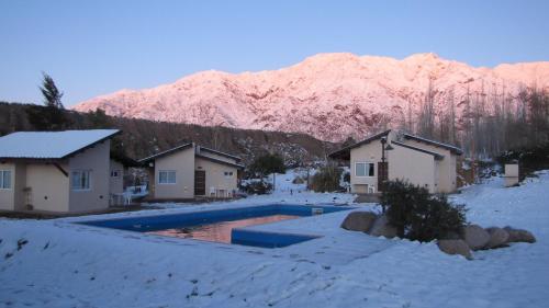 a resort in the snow with mountains in the background at Starry Lodge in Ciudad Lujan de Cuyo