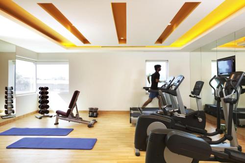 a woman running on a treadmill in a gym at ibis Chennai Sipcot - An Accor Brand in Chennai