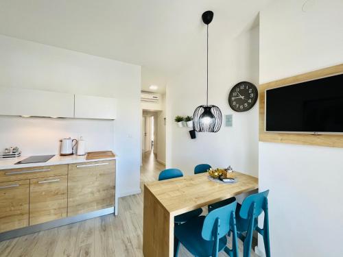 a kitchen and dining room with a table and chairs at Apartments and Rooms Mateša in Vodice