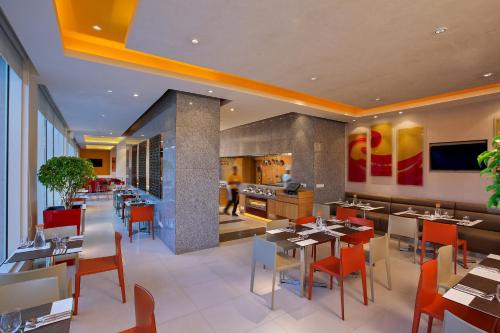 a dining room filled with tables and chairs at ibis Chennai Sipcot - An Accor Brand in Chennai