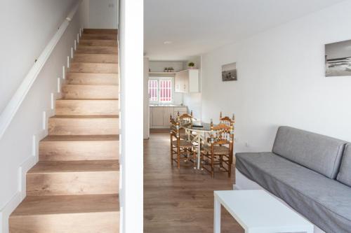 two views of a living room and staircase in a house at La Terraza de Agua Amarga in Agua Amarga