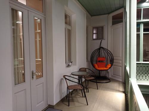 a room with a table and chairs and a door at La Maison #7 in Tbilisi City
