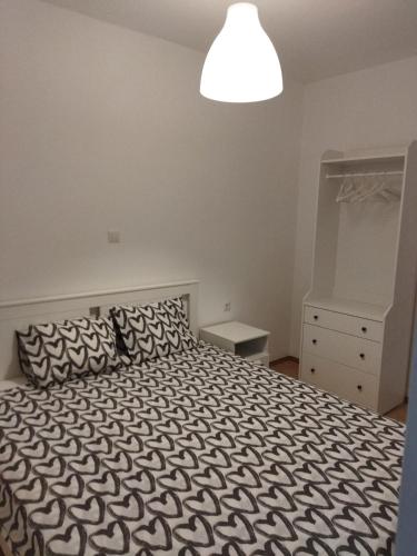 a bedroom with a black and white bed and a light at Teta Lidia in Krilo
