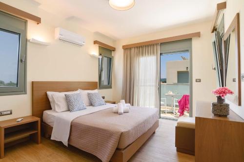 ein Hotelzimmer mit einem Bett und einem Balkon in der Unterkunft Villa Paleos Sunset by Villa Plus in Ialyssos